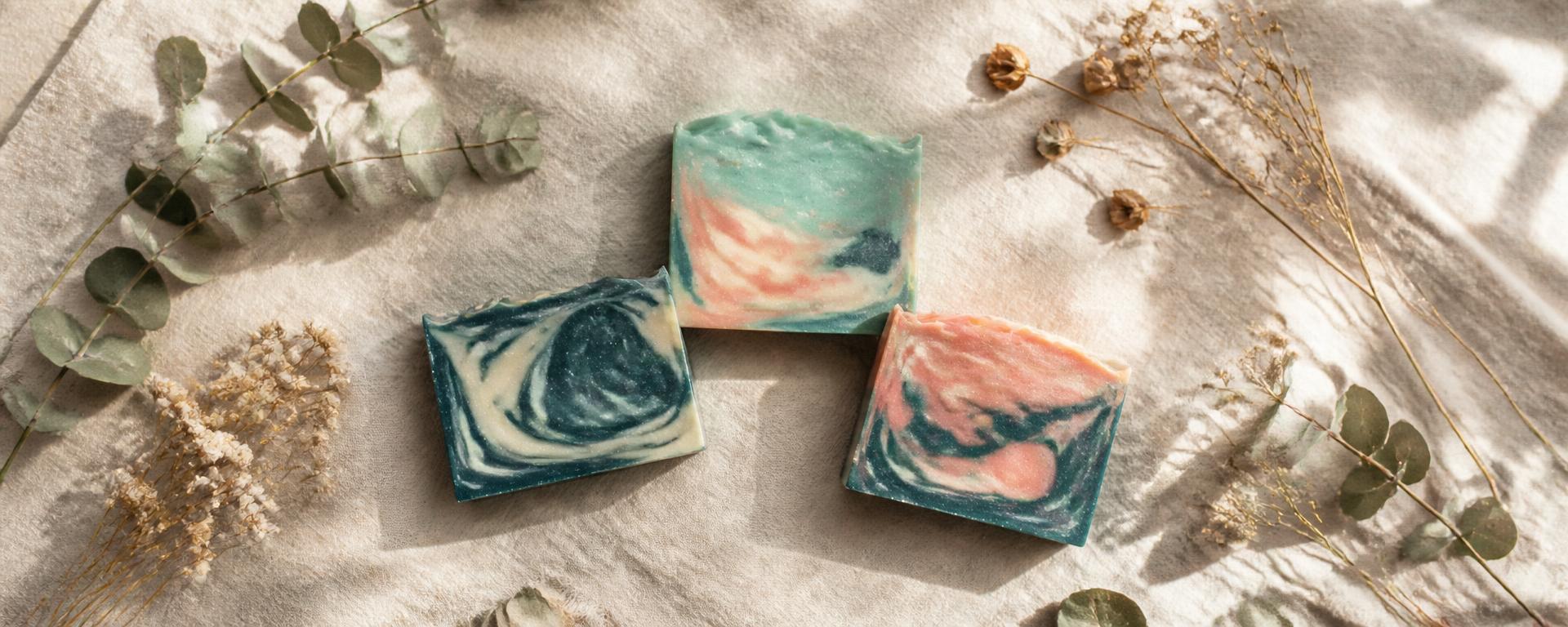 Handmade cold pressed YHWH natural soap bars styled on linen with dried botanicals